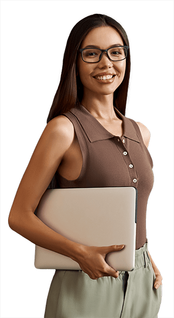Young smiling woman in glasses holding a laptop under her arm